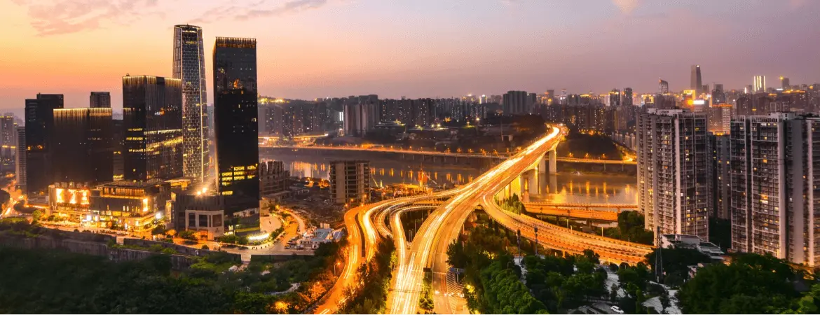 Night view of Ghaziabad city with illuminated highways, modern skyscrapers, and glowing skyline.
