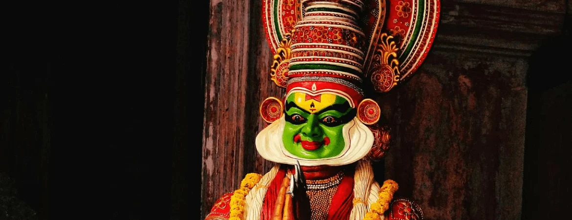 Kathakali dancer in traditional costume and green face makeup performing classical art form in Kochi, Kerala.